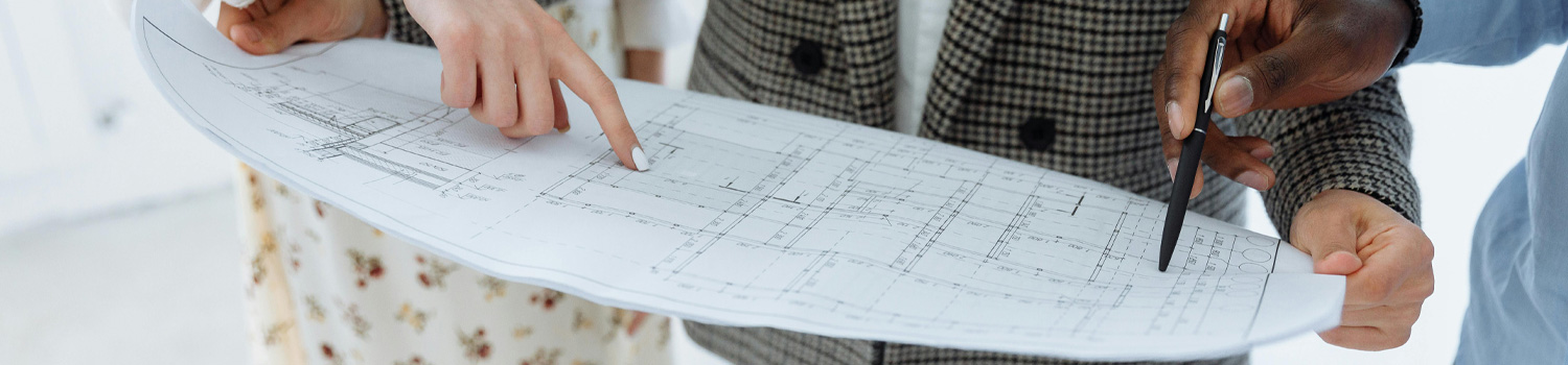 An image of a team looking at technical drawings.