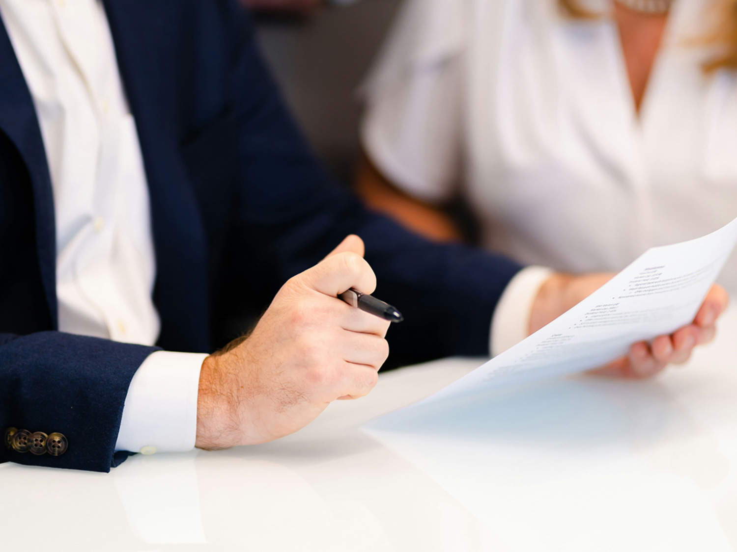 An image of two people looking at a document.